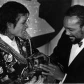 Michael Jackson, left, with Quincy Jones with armful of Grammys at the award show Feb. 28, 1984