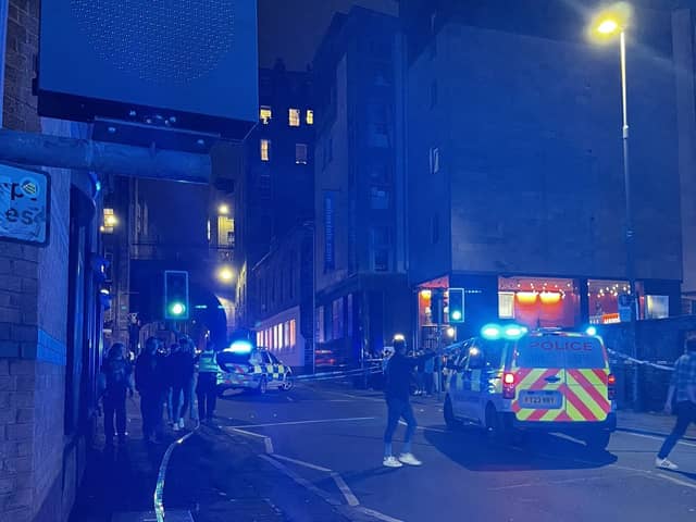 Emergency personnel in the Cowgate area of Edinburgh where a 74-year-old man died after being struck by a single decker bus. Picture: Roy/PA Wire