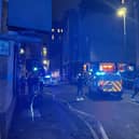 Emergency personnel in the Cowgate area of Edinburgh where a 74-year-old man died after being struck by a single decker bus. Picture: Roy/PA Wire
