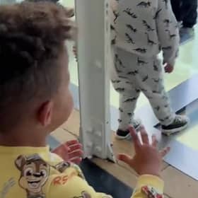 Mason Gee, 3, worried about his father Stephen Gee, 30, walking on a glass walkway