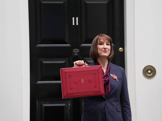 Chancellor Rachel Reeves poses outside 11 Downing Street with her ministerial red box before delivering her Budget in the House of Commons