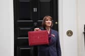 Chancellor Rachel Reeves poses outside 11 Downing Street with her ministerial red box before delivering her Budget in the House of Commons