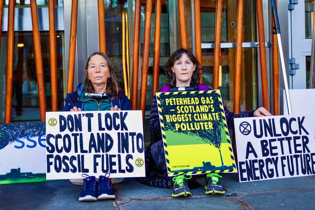 Extinction Rebellion protesters have locked themselves to the Scottish Parliament