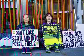 Extinction Rebellion protesters have locked themselves to the Scottish Parliament