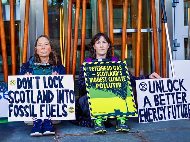 Extinction Rebellion protesters have locked themselves to the Scottish Parliament