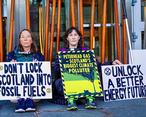 Extinction Rebellion protesters have locked themselves to the Scottish Parliament