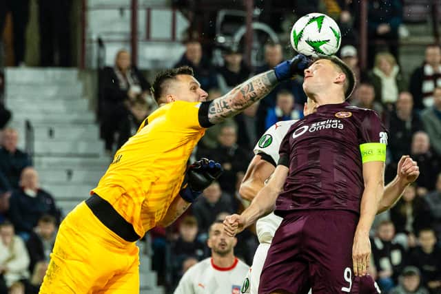 Hearts' Lawrence Shankland has the ball cleared from under his nose by Heidenheim keeper Kevin Muller.