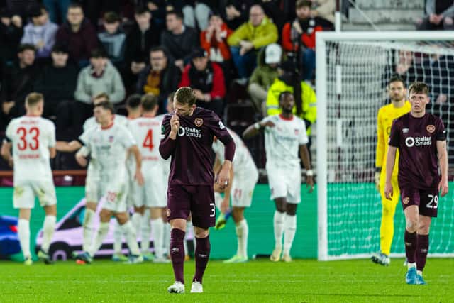 Hearts' players look on as Heidenheim celebrate the opener.