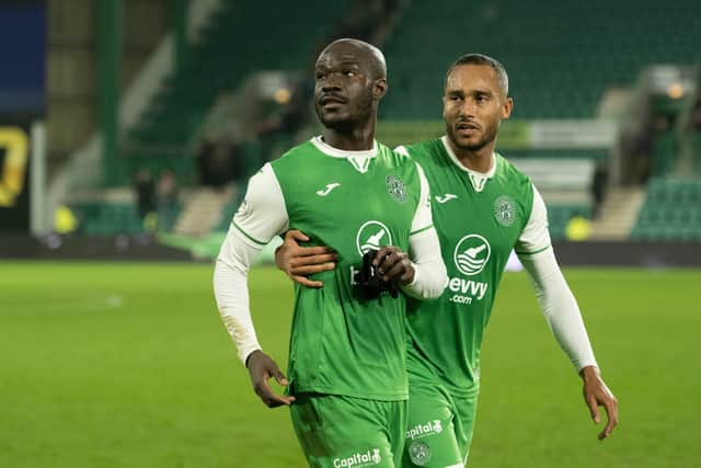 Elie Youan is gently escorted off the field by Jordan Obita after the French winger had engaged in a heated debate with fans at full-time after the defeat to St Mirren.