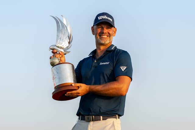 Englishman Paul Waring shows off the trophy after winning the Abu Dhabi HSBC Championship