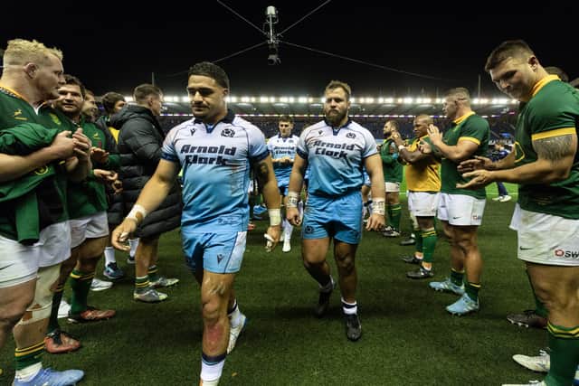 The Scotland players are clapped off by South Africa.