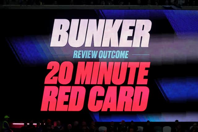 A general view as the LED screen displays the message "Bunker, Review Outcome, 20 Minute Red Card"