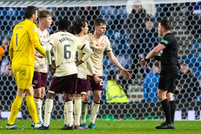 Hearts players surround referee Matthew MacDermid after the final whistle following the 1-0 defeat to Rangers at Ibrox. (Photo by Alan Harvey / SNS Group)