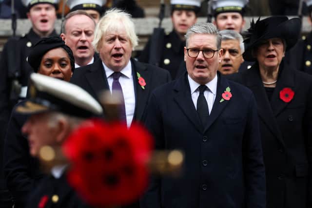 Britain's Prime Minister Keir Starmer sings the national anthem with former prime ministers Boris Johnson  and Theresa May during the Remembrance Sunday ceremony at the Cenotaph.