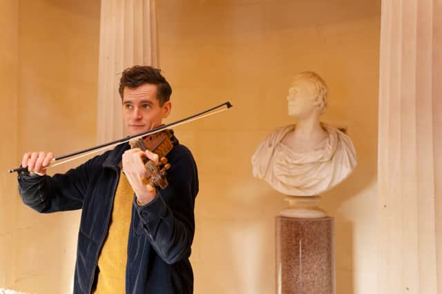 Musician Ewen Henderson with the ‘Gregg Fiddle’ at the Burns Monument in Alloway, Ayrshire.