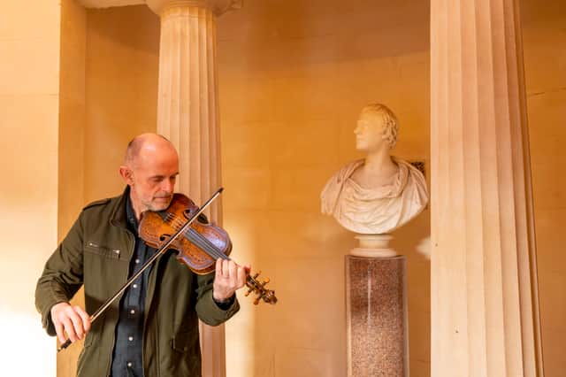 Musician Duncan Chisholm with the ‘Gregg Fiddle’ at the Burns Monument in Alloway, Ayrshire.