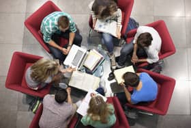 A group of university students studying in a circle. Dundee University has announced it is facing a 30 million pound deficit for the next financial year