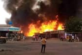A man watches as a fire rages in a livestock market in al-Fasher, the capital of Sudan's North Darfur state, following an attack by the Rapid Support Forces