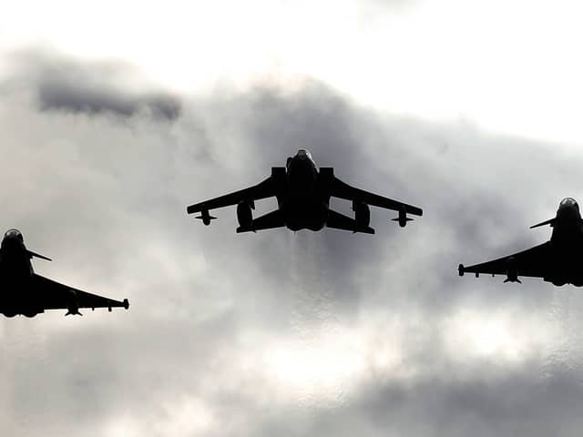 Two Typhoons and a Tornado jet fly past RAF Lossiemouth. Picture: PA