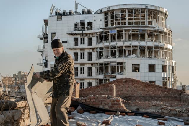 Mykola Hrishyn, 71, clears debris after Russian missile strikes on Kharkiv last month (Picture: Ivan Samoilov)
