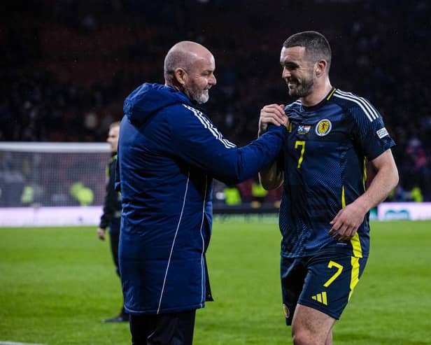 Scotland head coach Steve Clarke embraces goal scorer John McGinn at full time.