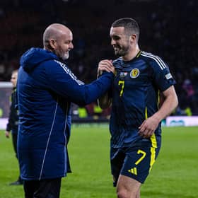 Scotland head coach Steve Clarke embraces goal scorer John McGinn at full time.