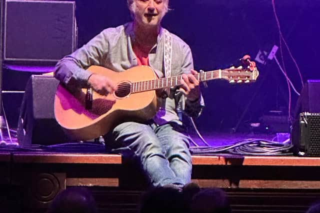King Creosote performs on the front of the stage as engineers try to fix the sound problems
