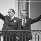 Russian leader Leonid Brezhnev, left, and US President Richard Nixon wave from the balcony of the White House during talks in June 1973. (Picture: Consolidated News Pictures)