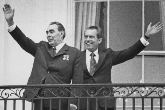 Russian leader Leonid Brezhnev, left, and US President Richard Nixon wave from the balcony of the White House during talks in June 1973. (Picture: Consolidated News Pictures)