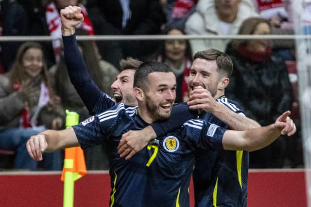 John McGinn celebrates scoring Scotland's opener against Poland in Warsaw. (Photo by WOJTEK RADWANSKI/AFP via Getty Images)