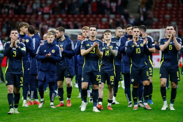 Scotland players celebrate their Nations League victory over Poland at the National Stadium in Warsaw. (Photo by WOJTEK RADWANSKI/AFP via Getty Images)