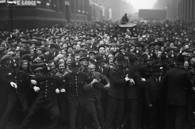 Police hold back a crowd outside Strangeways gaol in Manchester before the execution of Dr Buck Ruxton for the murder of his wife Isabella Ruxton and her maid Mary Rogerson (Picture: Fox Photos)