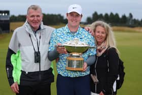 Bob MacIntyre shows off the Genesis Scottish Open trophy flanked by dad Dougie and mum Carol after his memorable win at The Renaissance Club in July