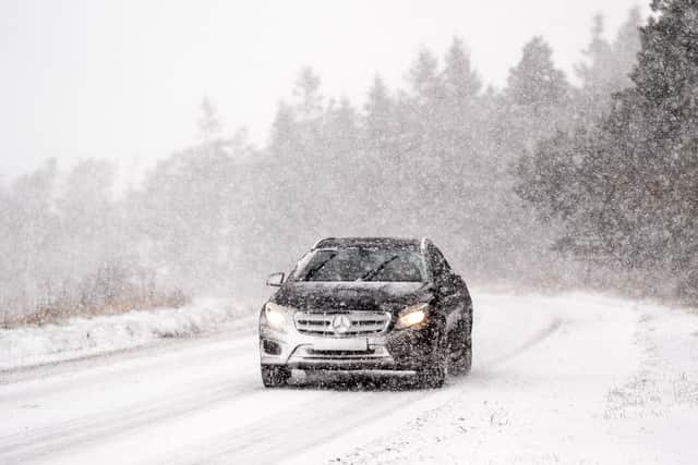 A car navigates snowy conditions. There is widespread travel disruption after heavy snowfall and ice affected parts of the UK. Picture: Danny Lawson/PA Wire