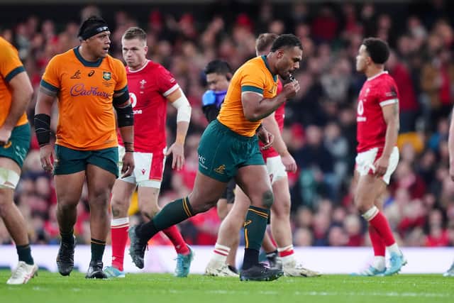 Australia's Samu Kerevi (centre right) recieves a yellow card, which was later upgraded to 20-minute red card, and leaves the pitch during the win over Wales.