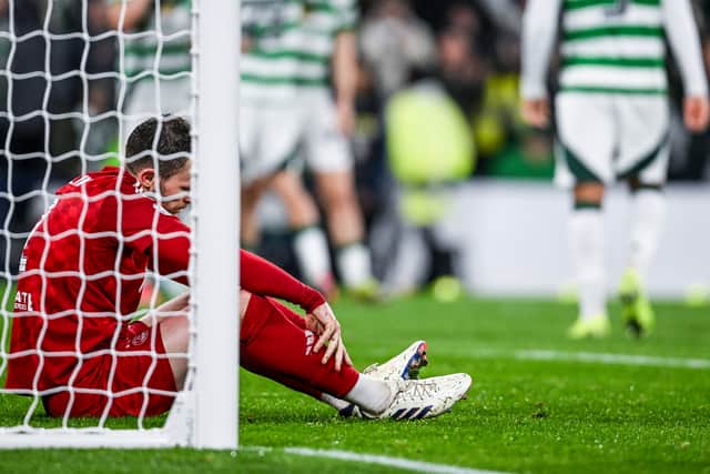 Aberdeen's Nicky Devlin looks dejected during the 6-0 Premier Sports Cup semi-final defeat to Celtic. Cr: SNS Group.