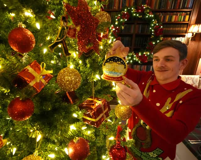 House Steward Joe Mackie in The Library as finishing touches are made to Christmas decorations at Dumfries House