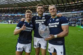 Scotland's Darcy Graham, Blair Kinghorn and Duhan van der Merwe with the Hopetoun Cup at full time.