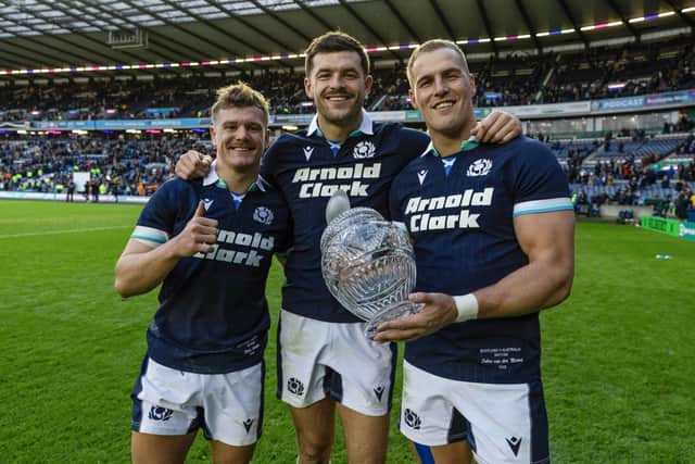 Scotland's Darcy Graham, Blair Kinghorn and Duhan van der Merwe with the Hopetoun Cup at full time.