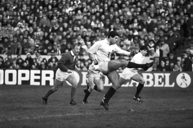 Gavin Hastings kicks the ball during his Scotland debut against France in the Five Nations in January 1986. Scotland win 18-17, with Hastings kicking six penalties.
