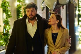 Tom Burke as Cormoran Strike and Holliday Grainger as Robin Ellacott.