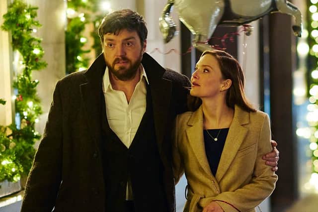 Tom Burke as Cormoran Strike and Holliday Grainger as Robin Ellacott.