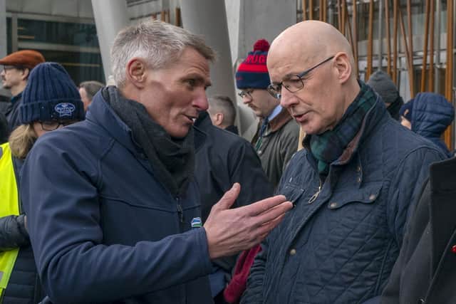 Jonnie Hall, policy director of the NFU, talks to First Minister John Swinney outside the Scottish Parliament.