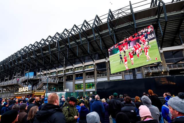 Fans watch the Wales v Fiji on the big screen outside the stadium before Scotland v South Africa. John McGuigan wants supporters to 'come earlier and leave later'.