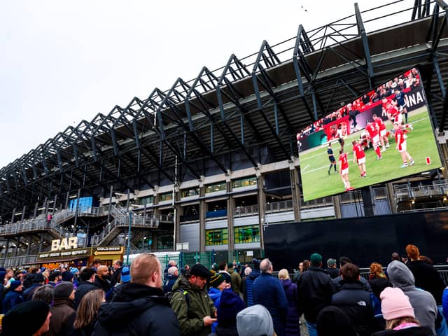 Fans watch the Wales v Fiji on the big screen outside the stadium before Scotland v South Africa. John McGuigan wants supporters to 'come earlier and leave later'.