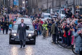People line the streets as Scottish comedian Janey Godley's hearse travels through Edinburgh on its way to her funeral service, which will be held at St Mary's Cathedral in Glasgow on Saturday