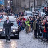 People line the streets as Scottish comedian Janey Godley's hearse travels through Edinburgh on its way to her funeral service, which will be held at St Mary's Cathedral in Glasgow on Saturday