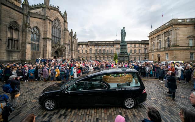 People line the streets as Scottish comedian Janey Godley's hearse travels through Edinburgh