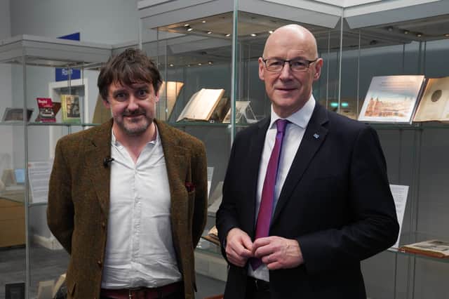 First Minister John Swinney with new Makar Peter Mackay at the Central Library in Edinburgh.  
