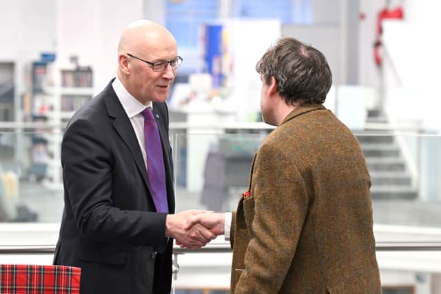 First Minister John Swinney with new Makar Peter Mackay at the Central Library in Edinburgh. 